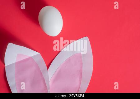 A symbolic Easter arrangement featuring white eggs and bunny ears, perfect for festive decor or advertising. Stock Photo