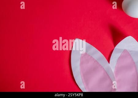 A symbolic Easter arrangement featuring white eggs and bunny ears, perfect for festive decor or advertising. Stock Photo