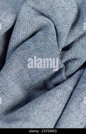 a piece of denim fabric for the production of clothing closeup, crumpled fabric, crumpled fabric Stock Photo