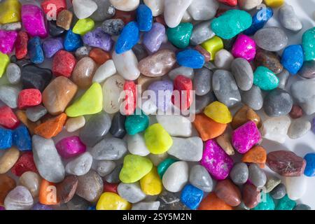 A collection of colorful pebble stones in various shapes on a white background. Stock Photo