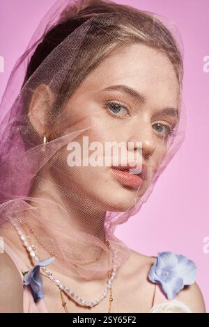 A stunning woman showcases chic spring fashion with floral prints and elegant accessories. Stock Photo