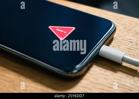 Phone battery charge error and problem. Charger usb cable issue. Overheating or low performance recharge in smartphone. Hot lithium mobile damage safe. Stock Photo