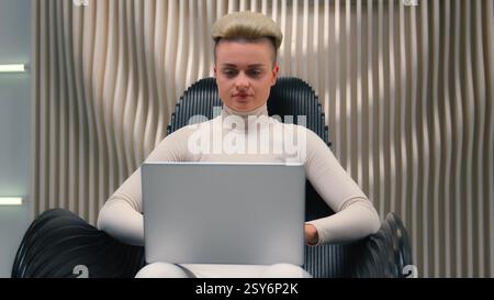 Caucasian woman girl in white neon futuristic space female IT programmer hacker coder gamer hacker software computer tech support typing laptop addict Stock Photo