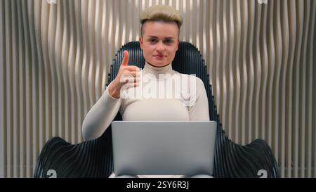 Caucasian woman girl in futuristic studio coder gamer female IT programmer hacker software computer tech support online work laptop modern virtual Stock Photo
