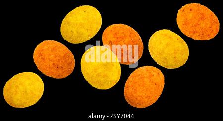 Falling coated peanuts isolated on black background Stock Photo