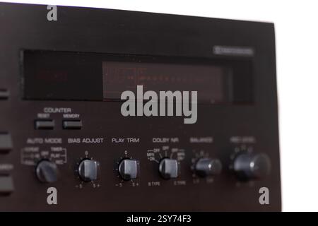 Retro audio equipment featuring detailed manual control panels for tuning and adjustments, highlighted by an illuminated display and distinctively mar Stock Photo