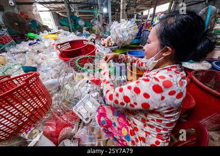 Local women sort plastic waste in a hall in the small village of Tan Thoi, Tân Thới, in the Mekong Delta. Stock Photo