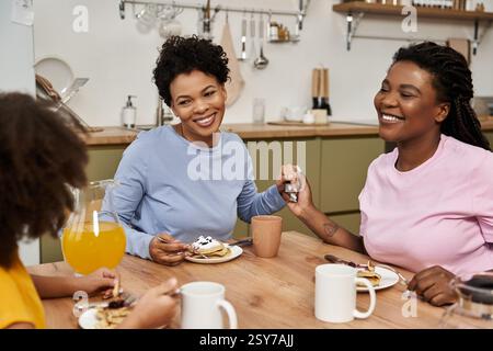 Enjoying a delightful breakfast together, sharing laughter and love as a family of three. Stock Photo