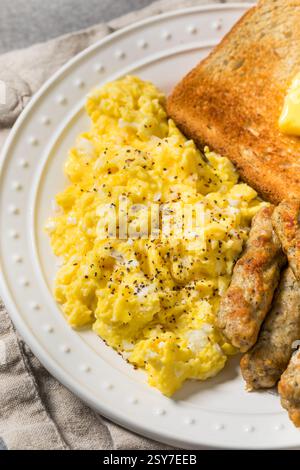 Healthy Homemade American Scrambled Egg Breakfast with Sausage and Toast Stock Photo