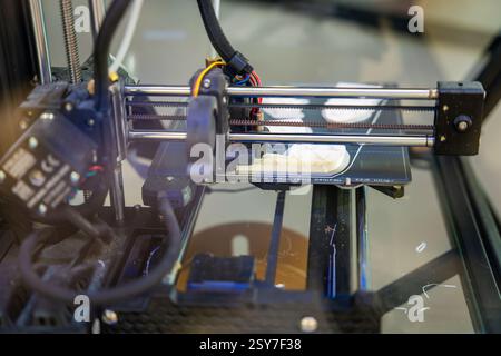 3D printer creating plastic objects with precision and speed. The concept represents modern manufacturing, rapid prototyping, and the future of custom Stock Photo