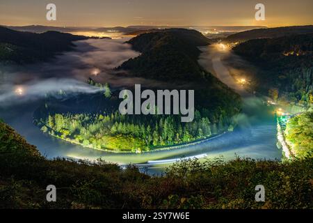 Whispers of Light: Cloef at Night Under Stars and Fog Stock Photo
