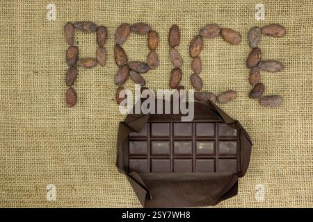 Chocolate Bar and Word Price from Cocoa Beans. Packaging. Jute Fabrick Background. Top View. Stock Photo