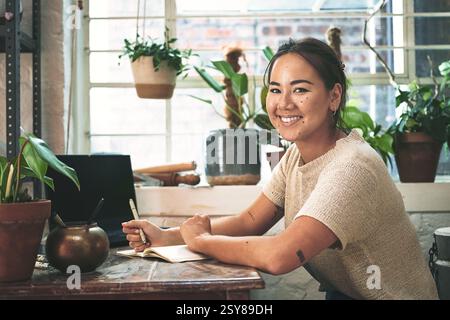 Asian woman, portrait and florist with book for online order, schedule or small business startup at floral store. Happy, female person or Stock Photo