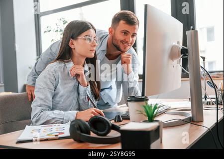 Two young designers is working together in the office. Stock Photo
