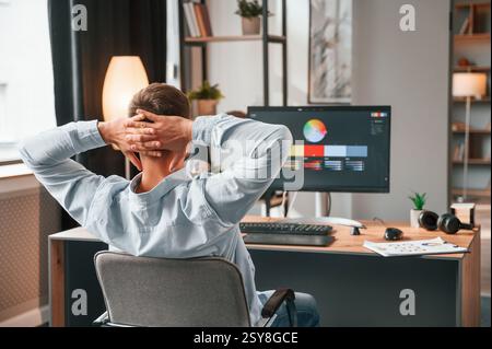 Designer is sitting by the computer and using graphics tablet with stylus. Stock Photo