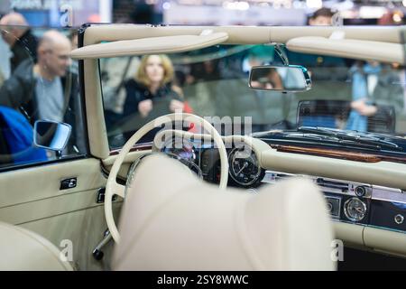 Classic convertible showcases timeless elegance at the auto exhibition, inviting onlookers to appreciate its vintage charm Stock Photo