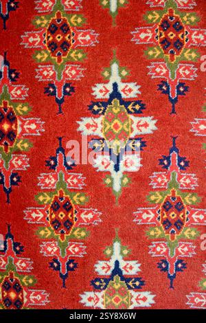 The blue, green, and red carpet's texture on the floor in the sunlight, closeup photo, beautiful cultural traditional art, background, wallpaper Stock Photo