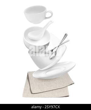 Clean dishware and silverware flying over napkin on white background Stock Photo