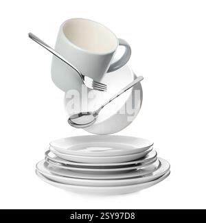 Clean dishware and silverware flying over stacked plates on white background Stock Photo