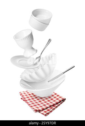 Clean dishware and silverware flying over red checkered napkin on white background Stock Photo