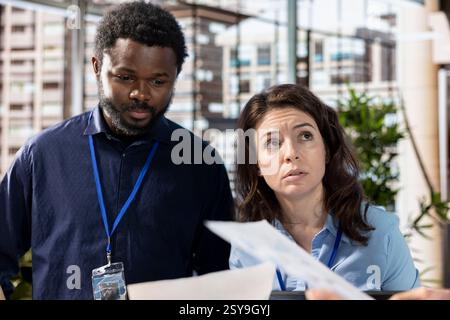 Team leader gathering staff members and analyzing the financial reports in a meeting, briefing each other on the current situation. Business associates working together for greatness. Stock Photo