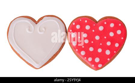 Two gingerbread cookies, white and red, with polka dots, isolated on white Stock Photo