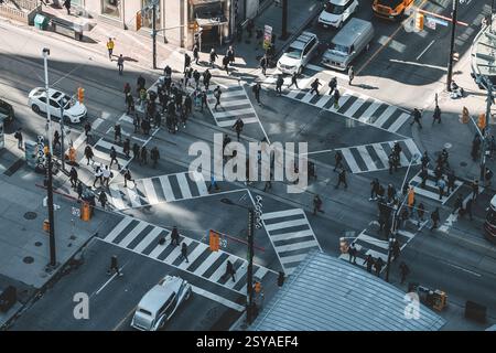 Toronto, Canada - April 8,2017: Aerial view of a busy intersection in Toronto showing Forever 21 store on corner, pedestrians crossing at multiple cro Stock Photo