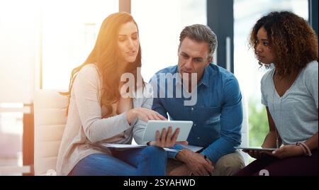 Creative people, meeting and discussion with tablet for brainstorming or project planning at office. Group, employees or web designers with technology Stock Photo