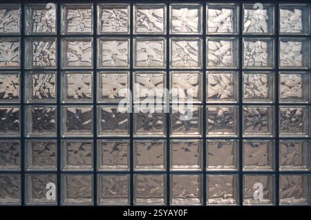 Aesthetic and modern design of textured glass block wall, capturing abstract patterns and light distortions. The photo was taken in Valdebebas, a majo Stock Photo