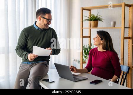 Business professionals collaborating on a project in a modern office. Team of coworkers sharing idea Stock Photo