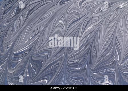 A captivating abstract design in grey and white, featuring elegant swirling patterns. This fluid texture resembles marble, adding a sophisticated touc Stock Photo