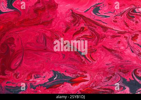 A striking abstract marble texture featuring vivid shades of acrylic red and pink, intertwined with dark accents. Perfect for artistic designs, backgr Stock Photo