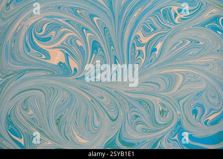 An abstract floral pattern with swirling blue and beige acrylic paint. This dynamic design creates a sense of movement and fluidity, perfect for backg Stock Photo