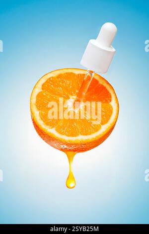 A dropper releases a clear fluid onto a fresh slice of orange, with a drop of juice dripping against a blue background. Stock Photo