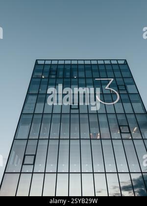 Corporate building with glass facade and a big number 3 Stock Photo