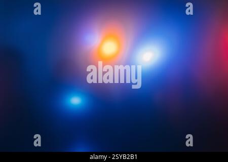 A vibrant blur of lights in blue, orange, and red tones creating an abstract and dynamic background. Ideal for creative designs and modern digital art Stock Photo