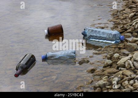 Environmental pollution, Household waste washed up on the lake shore, Plastic and glass bottles, Austria, Europe Stock Photo