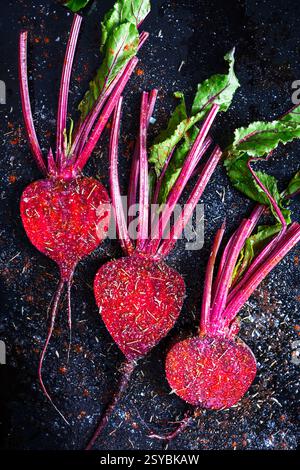 Three juicy beet slices with stems before baking in the baking oven. Top view. Cooking roasted beetroot with spices close up. Food photography Stock Photo