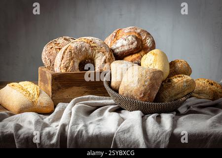 various freshly baked artissan bread on grey linen towel Stock Photo
