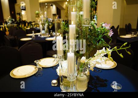 Wedding table setting with candles, flowers and cutlery Stock Photo
