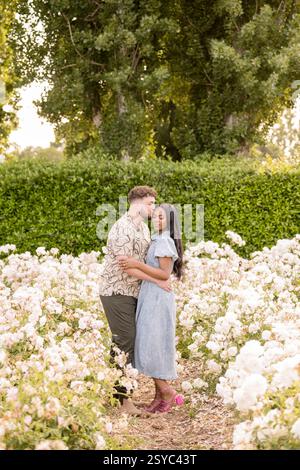 Man giving fiance a kiss on the cheek Stock Photo