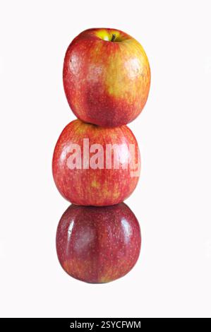 Three red apples, one on top of the other, of the Pink Lady variety. Very tasty. Stock Photo
