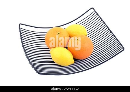 Citrus fruits in metal basket. Orange and lemon on white background. Stock Photo