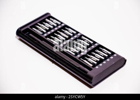 Set of screwdriver bits in a black box on a white background. Tools, screwdriver in a box. Screwdriver with different attachments Stock Photo