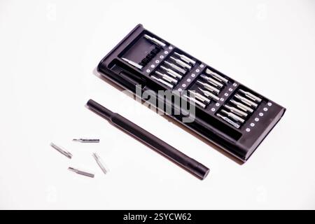 Set of screwdriver bits in a black box on a white background. Tools, screwdriver in a box. Screwdriver with different attachments Stock Photo