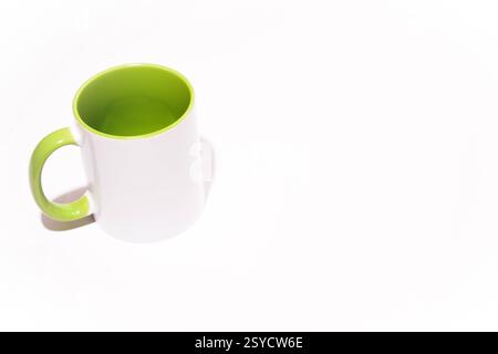 Cup on a white background. Green mug. Green cup or mug isolated on white. Coffee cup. Empty green tea cup. White and green ceramic cup Stock Photo