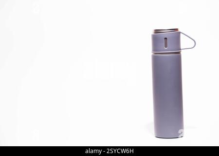 Thermos bottle isolated on white background. Aluminum can. Thermos and metal cups of coffee Stock Photo