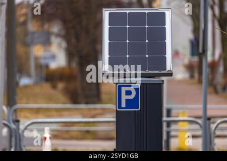 Parking meter for collecting parking fees in the center of an urban agglomeration, photovoltaic panel, parking zone Stock Photo