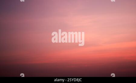 Calm sky in winter evening, Background image of sky gradient with beautiful pastel pink and orange and purple in the evening as the sun sets, Atmosphe Stock Photo
