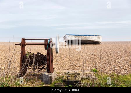 Abandoned Fishing Boat on the Beach at Aldeburgh on a February Afternoon with Very Old Rusted Winch in Foreground Stock Photo